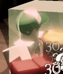 a man in a green hat is standing in a box with the number 30 on it