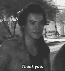 a black and white photo of a man saying thank you