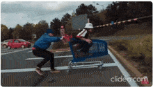 a man is pushing a shopping cart with a person in it