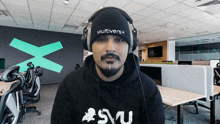 a man wearing headphones and a hat that says multivers on it