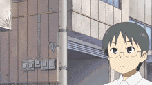a boy with glasses is standing in front of a building with a sign that says ' eee ' on it