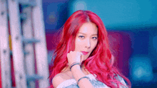 a woman with red hair is wearing a white top