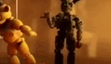 a close up of two toy figures standing next to each other in a dark room .