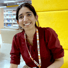 a woman wearing a lanyard that says " evolve " smiles for the camera