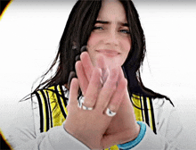 a woman wearing a yellow and black jacket with the letter n on it