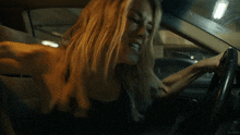 a woman is screaming while driving a car with kepler written on the bottom