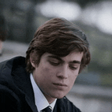 a close up of a young man 's face with his eyes closed