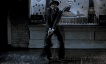 a man in a suit is dancing in the rain in front of a sign that says mahout .
