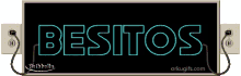 a neon sign that says " besitos " is hanging on a wall