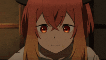 a close up of a girl 's face with red hair and orange eyes