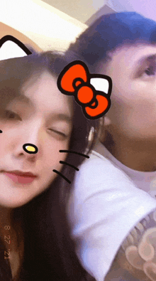 a man and woman with a hello kitty sticker on their face