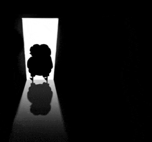 a silhouette of a person standing in the dark