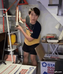 a man is standing in front of a box that says " star ball bay box "