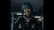 a woman with blue hair is wearing a black jacket with the number 83 on the back