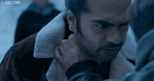 a man with a beard is being held by another man in a scene from the movie toms 2005