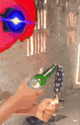 a person is holding a green bottle with a lighter in their hand