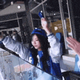 a girl wearing a jacket that says h.d. on the front