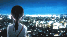 a girl in a ponytail looks out over a city