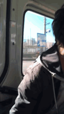 a person in a car looking out a window with a sign that says ' a ' on it