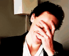 Laughs GIF - Shy Tom Hiddleston GIFs