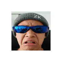a person wearing a beanie and sunglasses with the letter zk on it