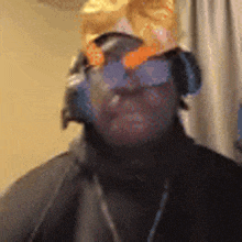 a man wearing headphones and a hat with a butterfly on it .