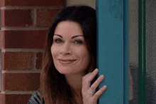 Carla Hiding Behind A Door And Smiles And Laughs Coronation Street GIF