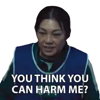 a woman wearing a blue vest with the number 044 on it says " you think you can harm me "