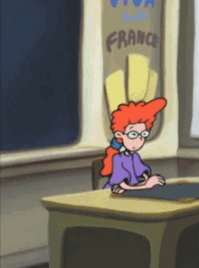 a cartoon girl sits at a desk in front of a france sign