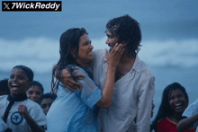 a man and a woman are hugging on a beach with x7wick reddy written above them