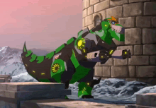 a green robot dinosaur is standing next to a stone wall