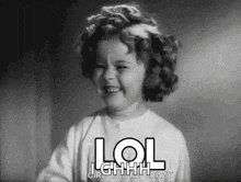 a little girl is making a funny face in a black and white photo with the words `` lol girl you 're crazy '' .