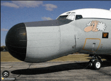 a plane with a cartoon face painted on the side of it