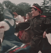 a man in a hat is dancing with a woman in a dress