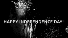 a black and white photo of fireworks with the words `` happy independence day '' in white letters .