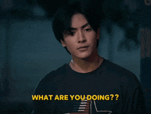 a young man in a black shirt is asking what he is doing