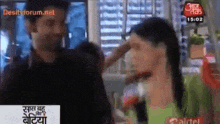 a man putting his hand on a woman 's forehead on a tv screen that says desitxforum.net