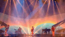 a group of people are playing instruments on a stage with a sunset in the background