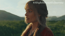 a woman stands in a field with the words #abigbold beautiful journey written above her