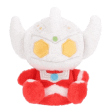 a red and white stuffed toy with a white head