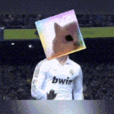 a soccer player wearing a bwir jersey holds a cube with a dog on it 's head