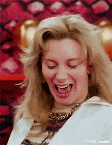 a woman with blonde hair is laughing with her mouth open and the words tumblr are below her