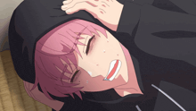 a girl with pink hair is laying on the floor with her hand on her head