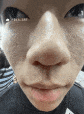 a close up of a person 's face with a pika art sticker on it