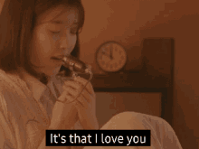 a woman singing into a microphone with the words " it 's that i love you " above her