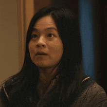 a close up of a woman 's face with a serious look on her face