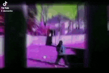 a blurred image of a person walking down a street in a video game .