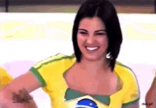 a woman in a yellow and green shirt with a brazilian flag on it