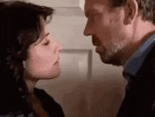 a man and a woman are kissing each other .