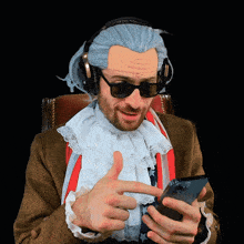 a man wearing a wig and sunglasses is looking at a cell phone and giving a thumbs up